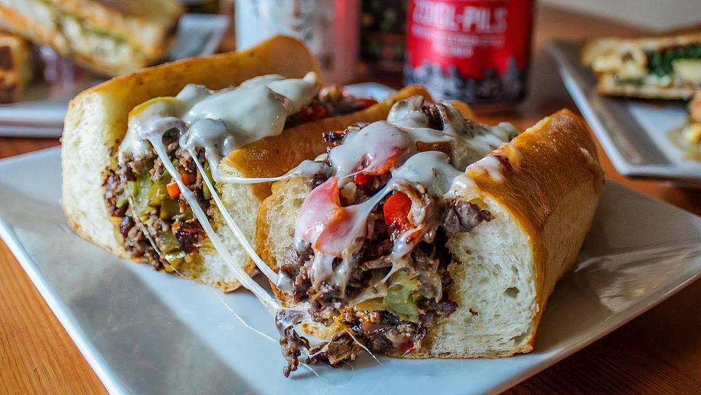 Cheesesteak · House roasted beef, provolone, grilled onions and peppers, and cherry peppers.
