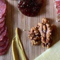 Charcuterie Board · Italian Salami, Coppa, Aged Manchego and Brie. Served with Accoutrements.