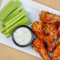 Chicken Wings · Eight baked chicken wings tossed in our homemade buffalo sauce served with blue cheese dress...