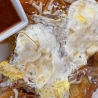 Chilaquiles · Corn tortillas cut in quarters and lightly fried, simmered in salsa, and served with cheese,...