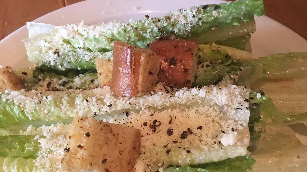 Caesar Salad · Traditional Caesar salad with house croutons.