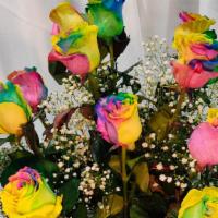 Rainbow Roses 1 Dozen · 12 rainbow roses in a vase with Greens and million star.