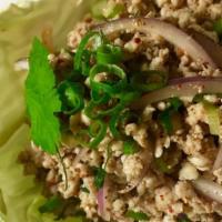 Larb Gai (Gf) · Minced chicken in a tasty mixture of lime juice, scallions, rice powder, red onion and cilan...