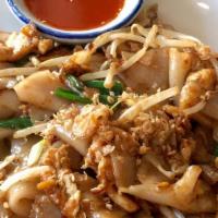 Kua Gai Noodle · Stir-fried wide rice noodle with bean sprout, green onion, and Sriracha sauce. Served on rom...