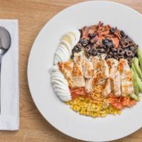 Cobb Salad · A blend of iceberg and romaine lettuce topped with chicken, bacon, corn, black olives, avoca...