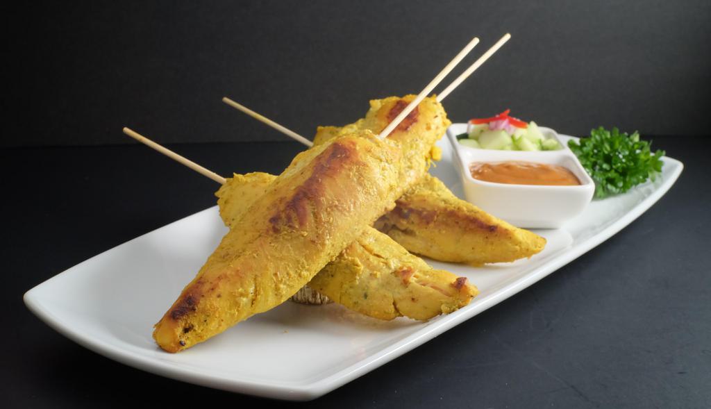 -Chicken Satay · Grilled chicken tenders marinated in herbs with curry powder and coconut milk. . Served with homemade peanut sauce and cucumber salad.