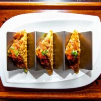 Spicy Tuna Tacos · Cubed spicy tuna, avocado, cilantro, masago, green onion, sweet chili aioli in a crispy wont...
