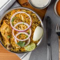 Chicken Dum Biryani · The perfect delicacy of choicest cuts of chicken cooked with saffron-hued basmati rice.