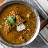 Goat Curry · Goat cooked in freshly ground spices with onions served with tomato gravy.
