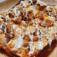 Buffalo Chicken Pizza · Buffalo Sauce Marinated Chicken, Caramelized Onions, Ranch and Mozzarella