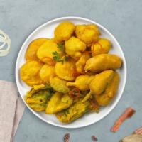 Pakora Mora · Assorted vegetables dipped in a light batter and fried until golden brown.