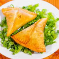Vegetable Samosa · Crisp pastry with potatoes and peas, deep fried.