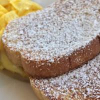 Traditional French Toast · Two thick slices of French toast grilled to golden perfection and a light dusting of powdere...