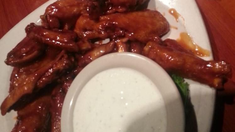 Ernie'S Own Wings (12) · Both wing and drum sections served plain or tossed in a sauce of your choosing.