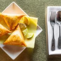 Samosas · Three pastries stuffed with savory. filling of ground beef onions jalapenos and spices. serv...