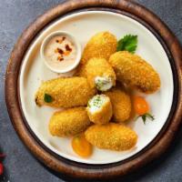 Jalapeno Poppers · (Vegetarian) Fresh jalapenos coated in cream cheese and fried until golden brown. Served wit...