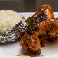 Drunken Hot Wings · Wings with spicy herbs topped with crispy basil. Served with sticky rice and sweet chili sau...