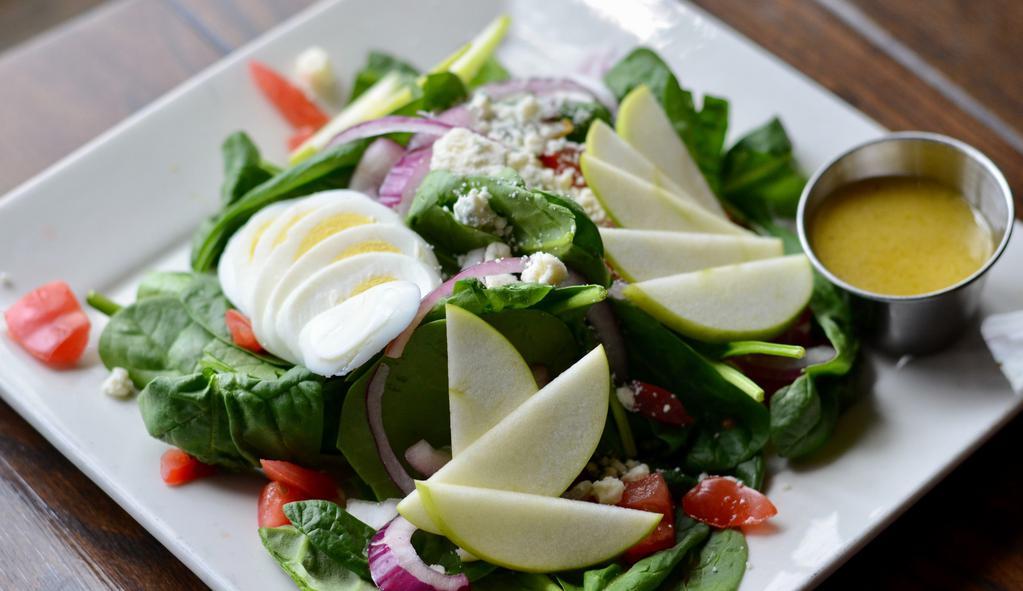 Spinach & Apple Salad · Spinach - egg - blue cheese crumbles - red onion - apple - apple bourbon vinaigrette.