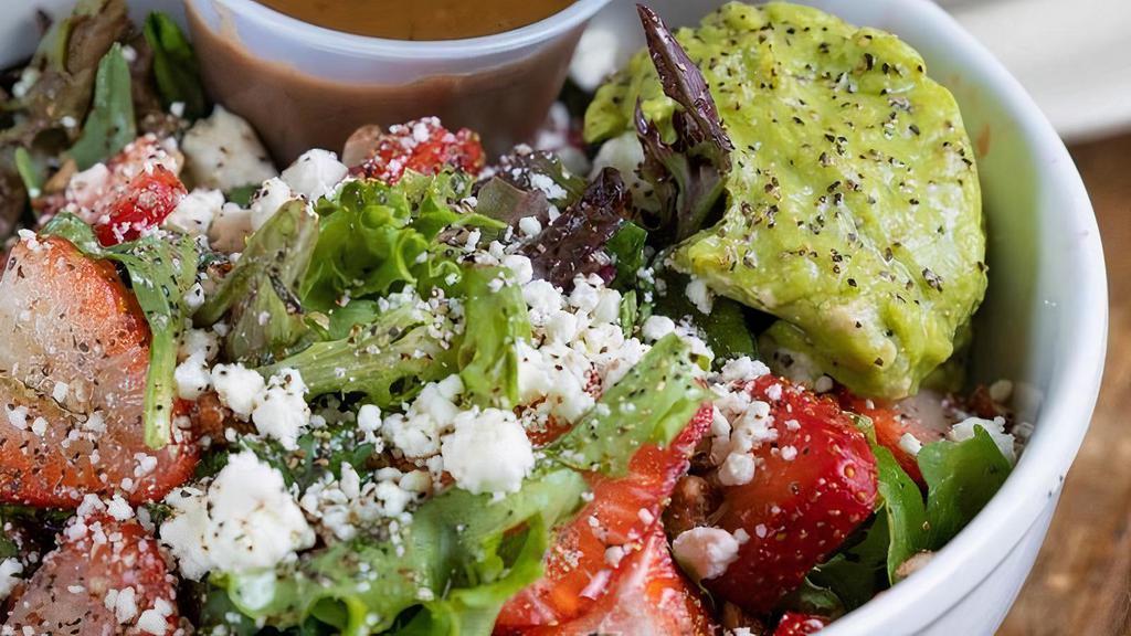 Strawberry Fields Salad · Mixed greens, strawberries mixed with goat cheese crumbles, diced tomatoes, pecans, avocado, served with house-made balsamic vinaigrette.