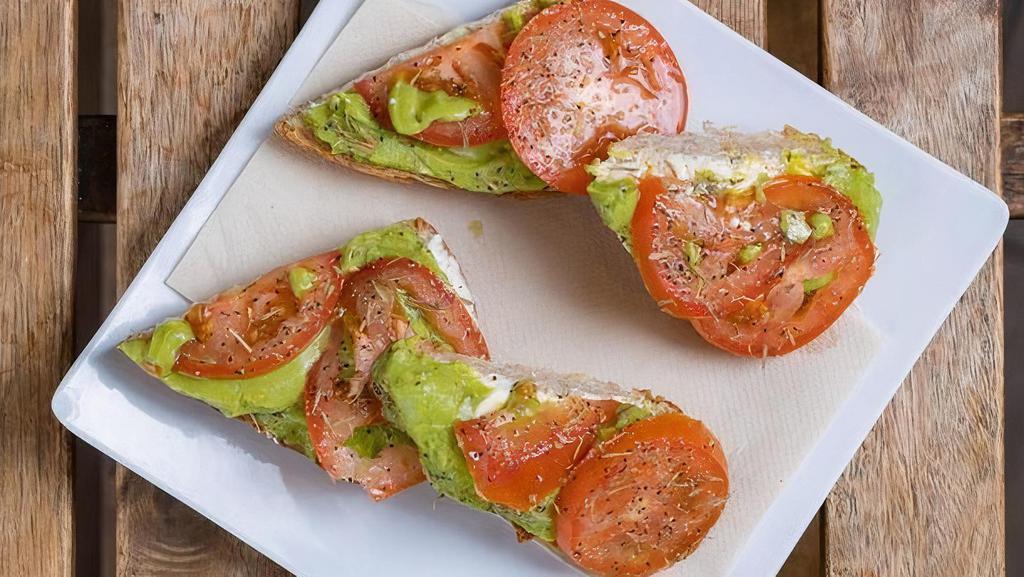 Avocado Toast · With avocado, sliced tomato, choice of goat's cheese or cream cheese, topped with seasonings.