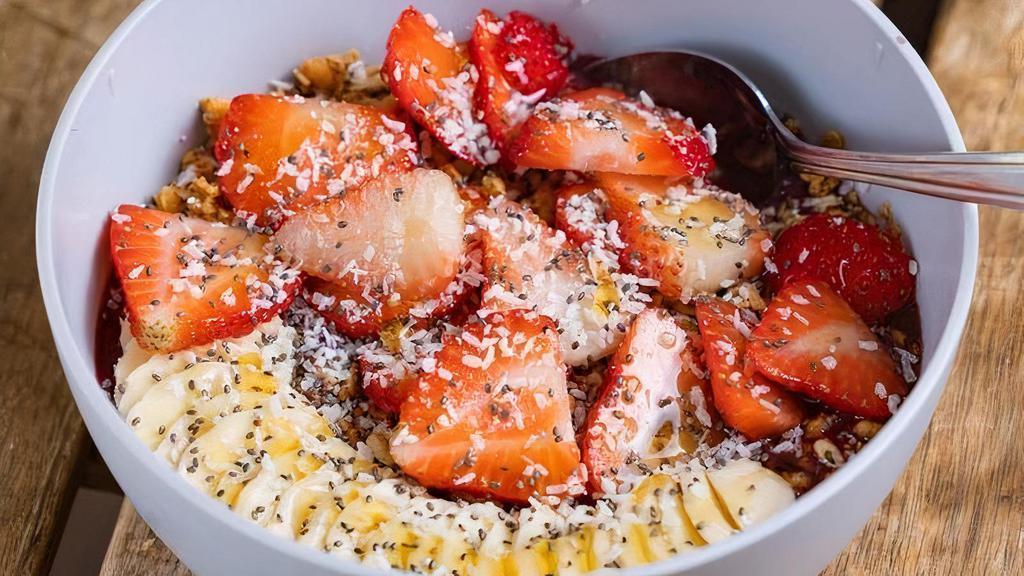Acai Bowl · Blended acai, blueberries, strawberry, banana and apple juice, topped with sliced strawberries, bananas, coconut flakes, honey and chia seeds over honey-oat granola.