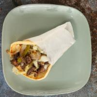 Steak Shawarma Philly Pita · Marinated steak, cooked off the vertical broiler, thinly sliced and topped with grilled onio...