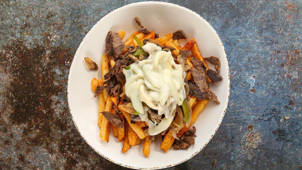 Steak Shawarma Philly Fries Bowl · Crispy fries, topped with steak shawarma, grilled onions, bell peppers, mushrooms, cheese, and choice of sauce.