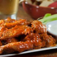 Spicy Pesto Wings · Gluten Free. Chicken wings sautéed in our homemade pesto buffalo sauce. Served with carrots,...