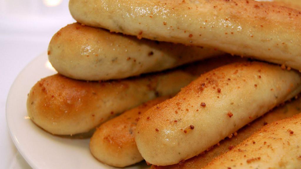 Breadsticks · Fresh baked, brushed with garlic butter and parmigiano cheese. Served with marinara sauce.