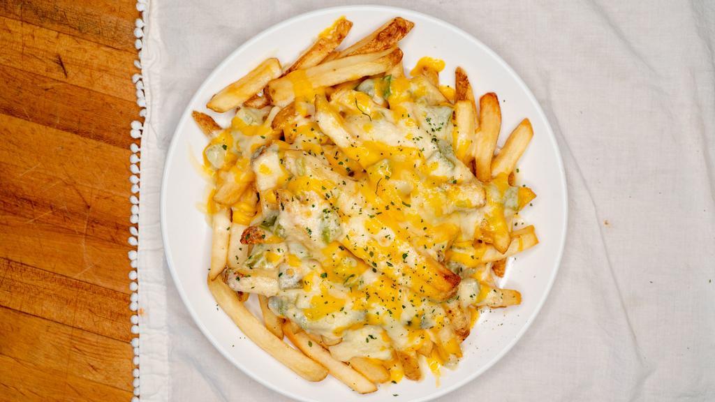 Green Chile Alfredo Fries · A basket of fresh made fries topped with green chile, alfredo and melted jack and cheddar cheese.