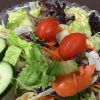 House Salad · A crisp garden salad or Caesar salad served with your choice of dressing.