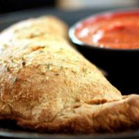 New York Philly Calzone · Roast beef, sautéed bell peppers, onions and mushrooms. Topped with provolone and mozzarella...