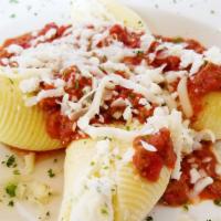 Pasta Shells · Pasta shells stuffed with ricotta and parmigiano cheeses. Topped with meat sauce and mozzare...