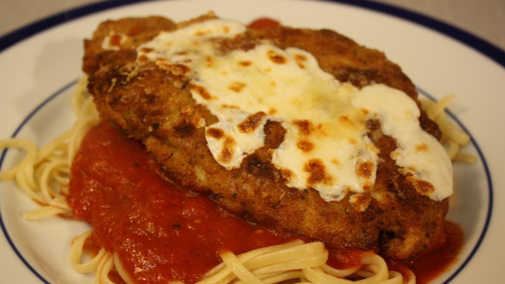 Chicken Parmigiana · Lightly breaded chicken breast baked in marinara sauce and mozzarella cheese. Served with a side of spaghetti.
