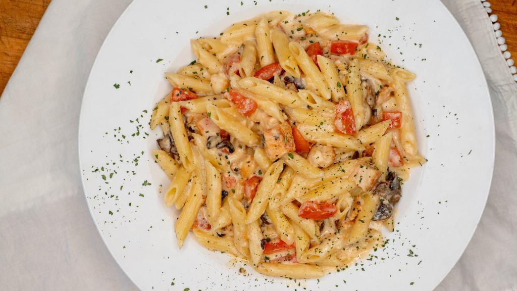 Southwest Chicken · Grilled chicken, mushrooms and diced tomatoes tossed with penne pasta in our green chile alfredo.