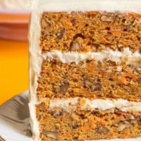 Giant Carrot Cake · Four Monster layers of moist carrot cake. Made with real cream cheese icing and finished wit...