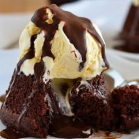 Gluten Free Lava Cake · Dark and decadent flourless chocolate cake with a silky chocolate ganache. Served with vanil...