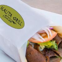 Traditional Gyro · Gyros wrapped in grilled pita with lettuce, tomatoes, onions, topped with house tzatziki sau...
