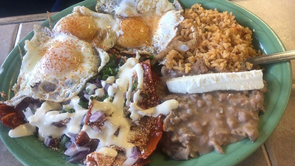Chilaquiles Con Huevo · 2 eggs, chips with red or green salsa, Mexican cheese, onions, cilantro, sour cream rice, and beans.