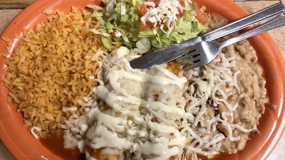 Enchiladas Rojas · 2 enchiladas choice of meat. Served with sour cream, cheese, rice, beans, and side salad.
