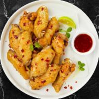 Chili With Me Wings  · Fresh chicken wings breaded, fried until golden brown, and tossed in sweet chili sauce. Serv...