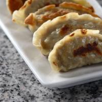Pot Stickers · Homemade pan-seared dumpling filled with ground pork and vegetables.