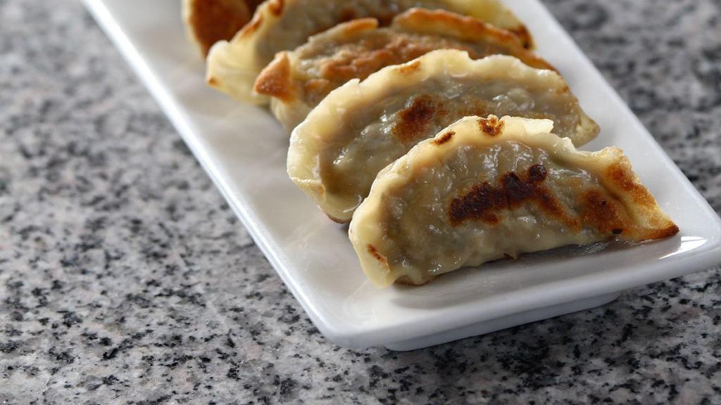 Pot Stickers · Homemade pan-seared dumpling filled with ground pork and vegetables.