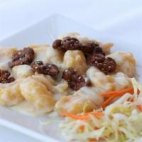 Honey Walnuts Shrimps · Exquisite rich sauce, topped with glazed caramelized walnut and a dash of sesame seeds. Serv...