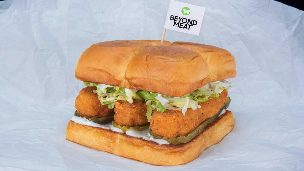 Beyond® Bad Mutha Clucka · Two crispy fried Beyond® tenders (plant based), spiced to your liking, Plain, Nashville Hot or Nashville Hotter with miso ranch, dill pickle slices and lettuce; served on King's Hawaiian rolls.