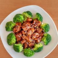 Sesame Chicken · Chunks of chicken deep fried and served with steamed broccoli sauteed with sweet and spicy b...