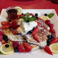 Blueberry Pancakes · Three large pancakes served with butter and syrup.