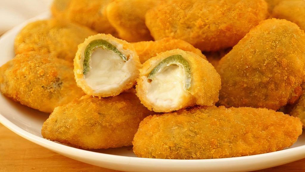 Jalapeno Poppers · Deep Fried fresh Jalapeno's stuffed with house popper stuffing and wrapped in apple wood smoked bacon. 4 per order