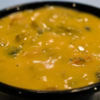 Chips & Chile Con Queso · House made seasoned tortilla chips with our famous Hatch Green Chile con Queso.