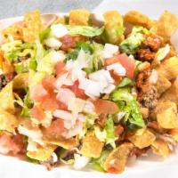 Frito Pie · Fritos corn chips topped with house made pinto beans, Cheese, ground beef, and our own Red C...